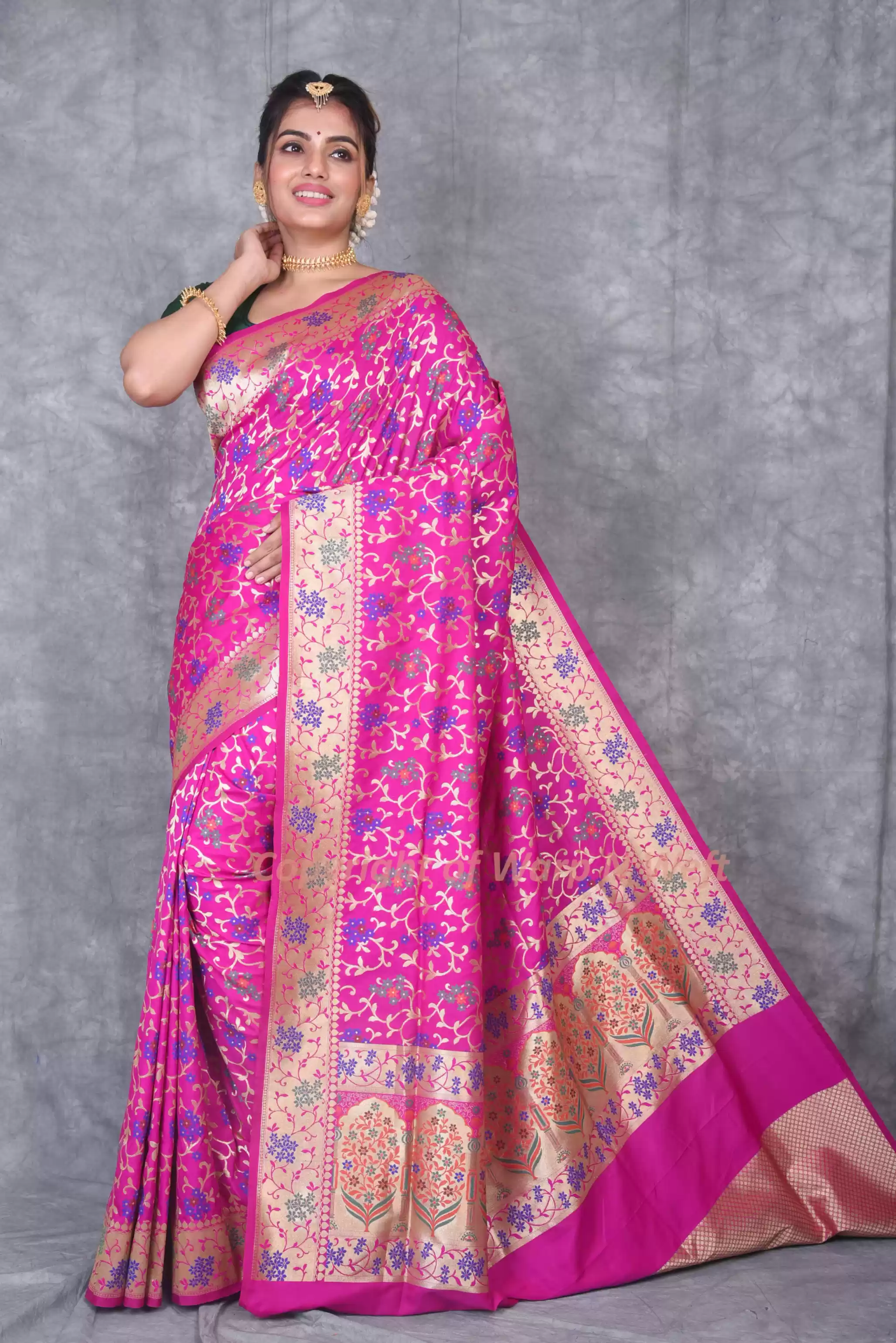 Vibrant pink Banarasi silk saree featuring intricate jaal weave and floral designs, perfect for fest.